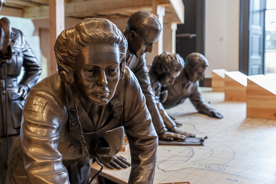 Bronze style model of a women leaning over a map of Britain in the Museum's recreation of a Filter Room